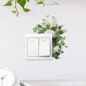 Modern white double light switch with orange indicators and green floral wall stickers