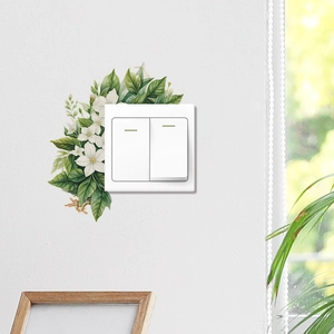 Detailed view of floral light switch wall decal with green leaves and white flowers