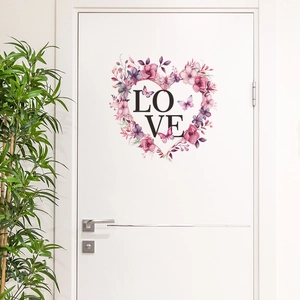 Close-up of heart-shaped floral wall sticker with LOVE text on a white interior door