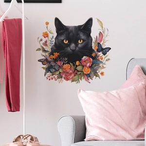Detail view of cartoon black cat and pink rose wall stickers in a cozy living room setup