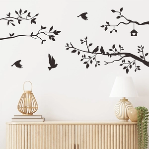 Black silhouette wall sticker featuring tree branches, birds and birdhouse on white wall