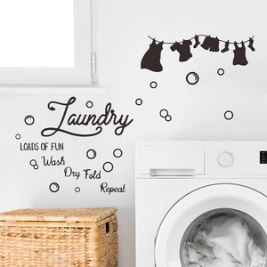 Laundry room wall decal with 'LOADS OF FUN' text and laundry silhouette on a white wall