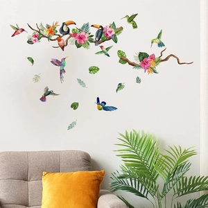 Tropical wall stickers featuring hummingbirds and pink hibiscus flowers in a cozy living room