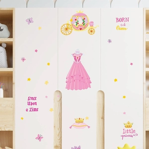 Detail view of pink princess carriage and crown wall stickers applied on a white wooden closet