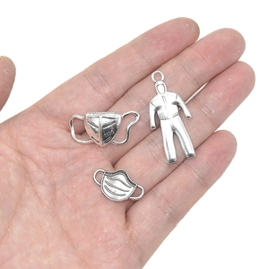 Silver retro alloy charms featuring N95 mask and protective suit design in palm