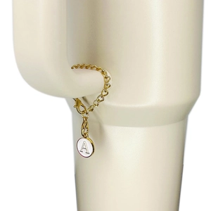 Golden keychain with letter A charm and lobster clasp attached to a water bottle