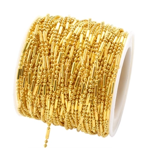 Macro view of 1.5mm golden bamboo chain on a spool for DIY jewelry and hair accessories