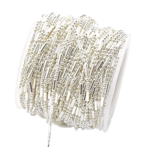 Close-up of silver-plated 1.5mm bamboo-style metal chain on white spool for DIY jewelry