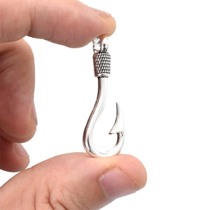 Antique silver fish hook pendant in alloy with detailed mesh texture and barbed design