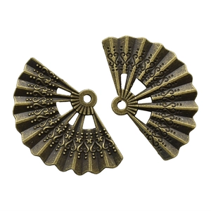 Detailed close-up of bronze alloy fan pendants with embossed floral patterns and hanging holes