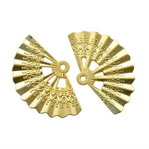 Detail of vintage gold fan-shaped alloy pendants with intricate hollow relief patterns