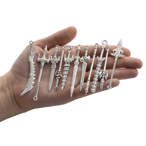 Set of 11 vintage silver alloy weapon charms including swords and axes for DIY jewelry crafts