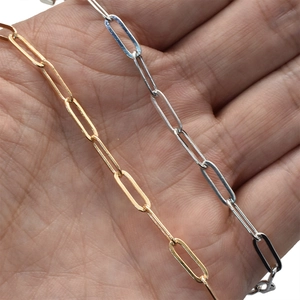 DIY copper paperclip chain links in gold and silver finish shown on palm for size scale