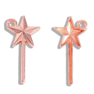 Macro view of rose gold star magic wand pendant showing both front and back textured details
