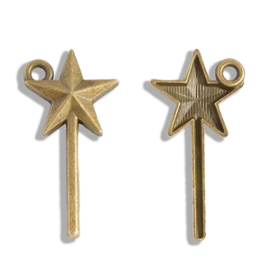Detailed macro view of vintage bronze fairy wand pendants with star shape for DIY jewelry