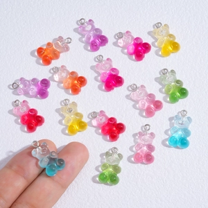 Detailed view of colorful translucent gummy bear resin charms with metal loops for DIY jewelry