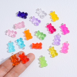 Macro view of colorful resin gummy bear pendants with metal rings for jewelry making