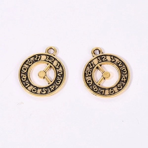Detailed macro view of two vintage bronze clock pendants with mechanical gear design