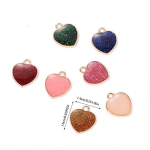 Macro view of colorful glitter heart pendants in alloy for DIY jewelry 1.4cm x 1.6cm