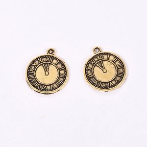 Macro view of vintage bronze alloy clock pendants with Roman numerals for DIY jewelry