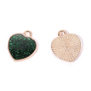Detail of heart pendants showing green glitter enamel front and golden textured metal back