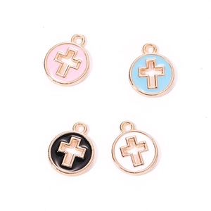 Detail view of colorful cross pendants in gold alloy for DIY jewelry and necklaces