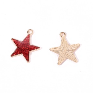 Detailed macro view of two alloy star pendants with red glitter oil and sunray texture