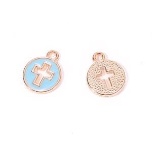 Detail of round cross charms with sky blue enamel and embossed metal texture for DIY