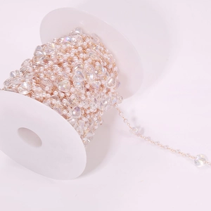 Detailed view of DIY heart mermaid pearl chain wound on white plastic spool spooling