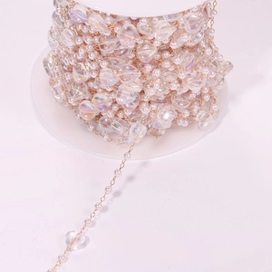 DIY iridescent mermaid heart pearls with small white beads on a golden metal chain link