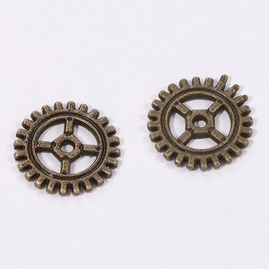 Macro shot of 10mm antique bronze steampunk gear charms for industrial DIY jewelry making