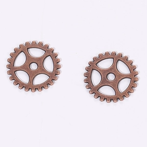 Detailed macro view of 15mm copper steampunk gear charms for DIY jewelry making and crafts