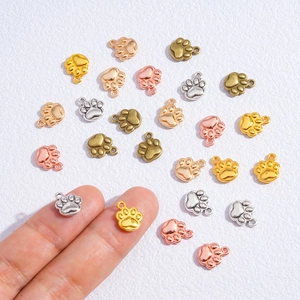Miniature metal cat paw charms in gold and silver finishes for DIY jewelry making