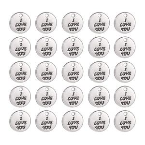 Macro detail of 25 silver-tone 10mm alloy charms with I Love You engraved text