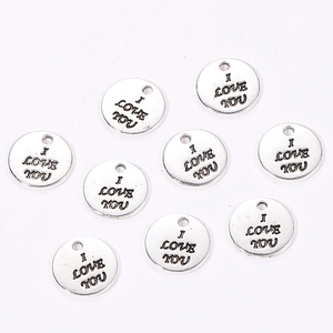 Macro detail of silver round I Love You alloy charms for DIY jewelry and necklaces