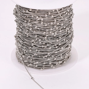 Silver-plated DIY copper box chain with bead accents on a professional white spool