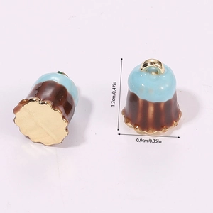 Macro view of 3D miniature Canelé charms in brown and blue with size measurements