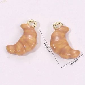 Macro shot of 3D miniature croissant pendants with glossy glaze and size dimensions