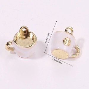 Detailed macro view of 3D miniature coffee cup charms with golden heart embossing