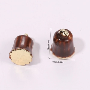 Macro view of 3D miniature brown canelé food pendants with precise dimensions