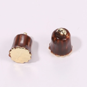 Detailed close-up of brown enamel bell-shaped pendant with gold metal hardware