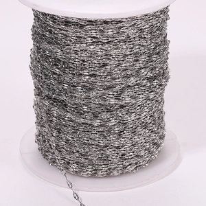 Close-up of bright silver sun flower lip chain roll with detailed textured metal links