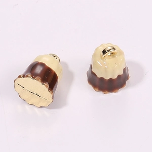 Detailed view of Canelé dessert pendants with dual-tone finish and golden hanging loops