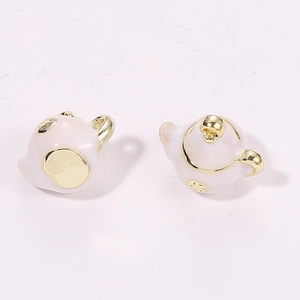Macro view of 3D miniature ceramic teapots with gold trim for DIY jewelry making
