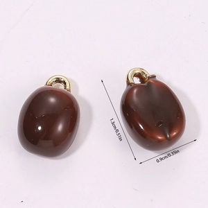 Macro view of a 3D resin coffee bean pendant with dimensions 1.3cm by 0.9cm