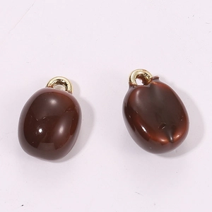 Detailed view of 3D miniature dark brown coffee bean charms with gold metal rings