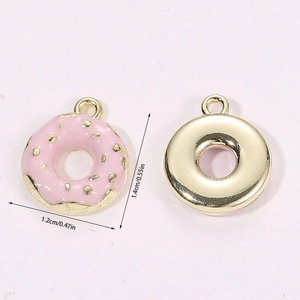 Macro detail of 3D miniature pink doughnut pendant with golden metal back and dimensions