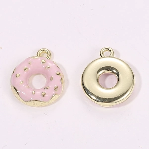 Detailed view of 3D donut pendants with pink enamel coating and golden metallic backside