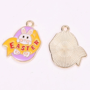 Detail of Easter rabbit egg charm showing purple enamel front and golden metal back