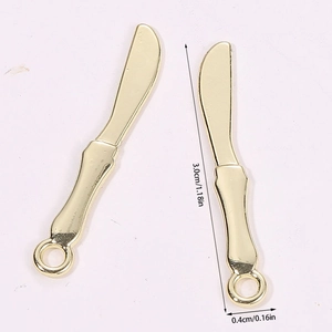 Macro view of gold butter knife pendants showing 3.0cm length and 0.4cm width dimensions